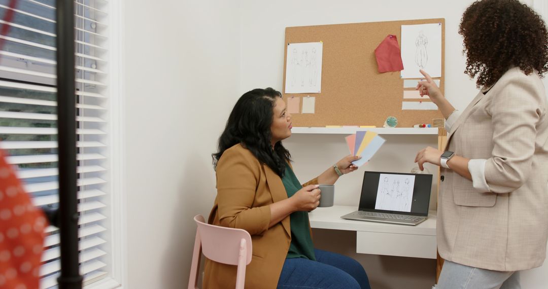 Designers collaborating over color swatches and sketches at modern creative studio