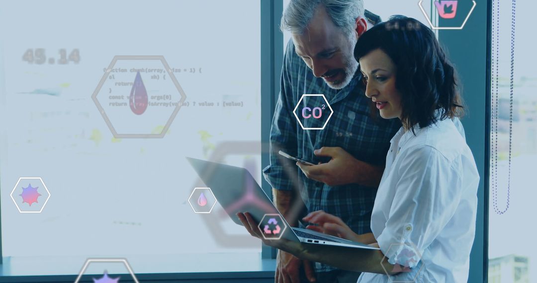 Colleagues Analyzing Ecological Data on Laptop with Icons Overlay