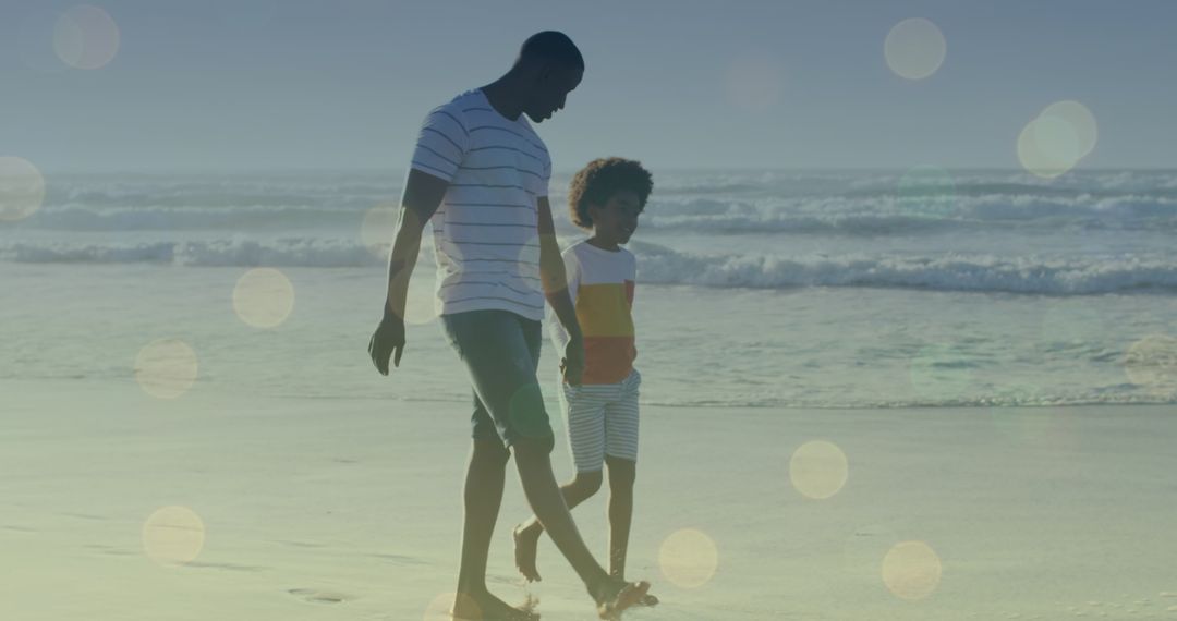 Father and Son Walking on Beach with Ethereal Light Spots