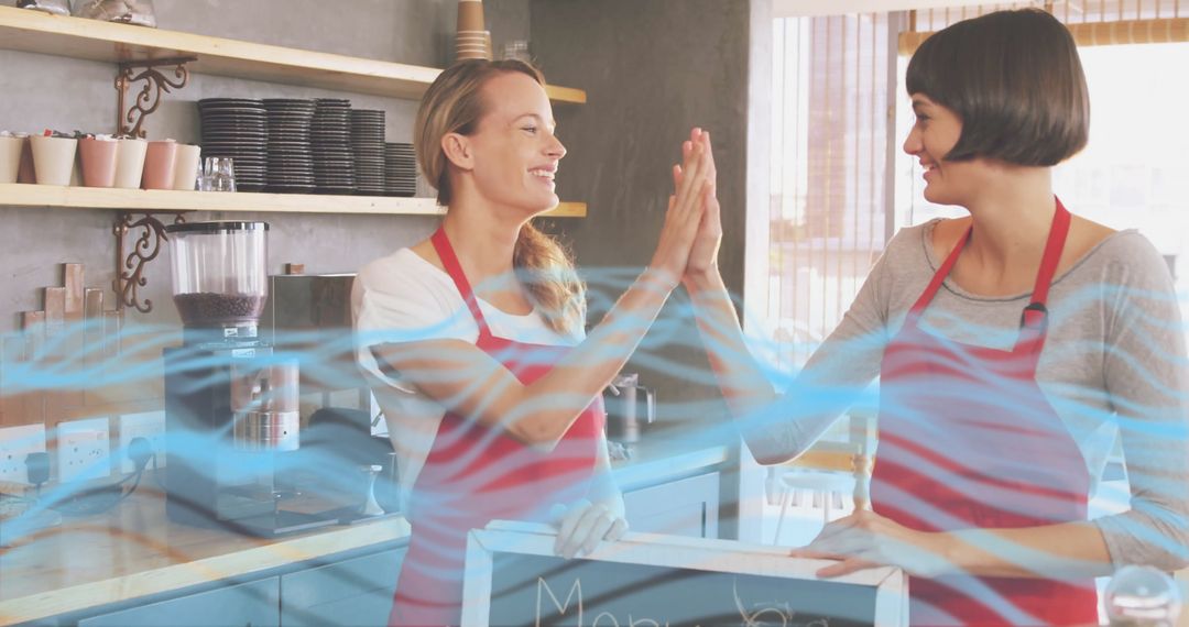 Collaborative Cafe Staff High-Fiving Behind Counter