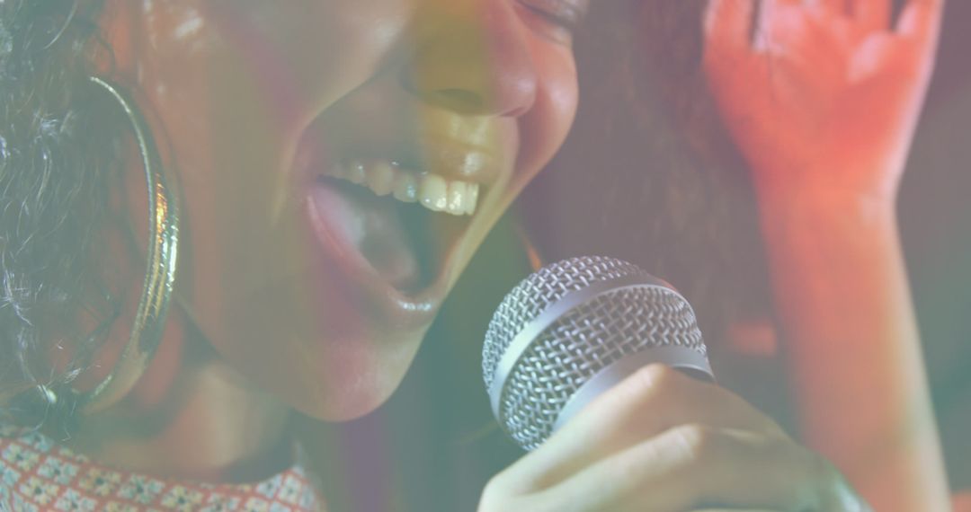 Woman Singing Joyfully into Microphone - Free Images, Stock Photos and Pictures on Pikwizard.com