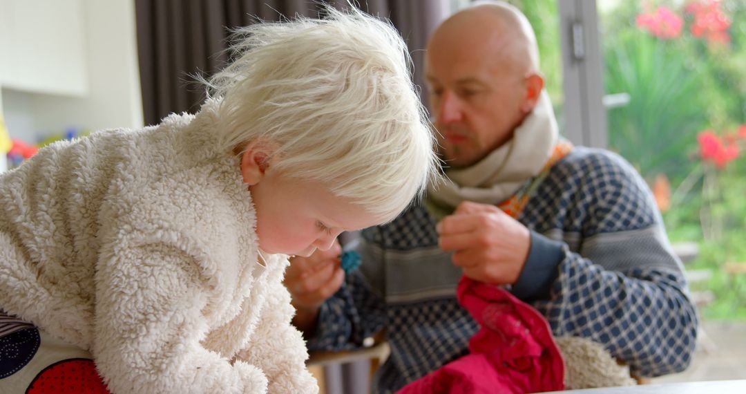Father with Young Daughter Engaged in Creative Activities at Home