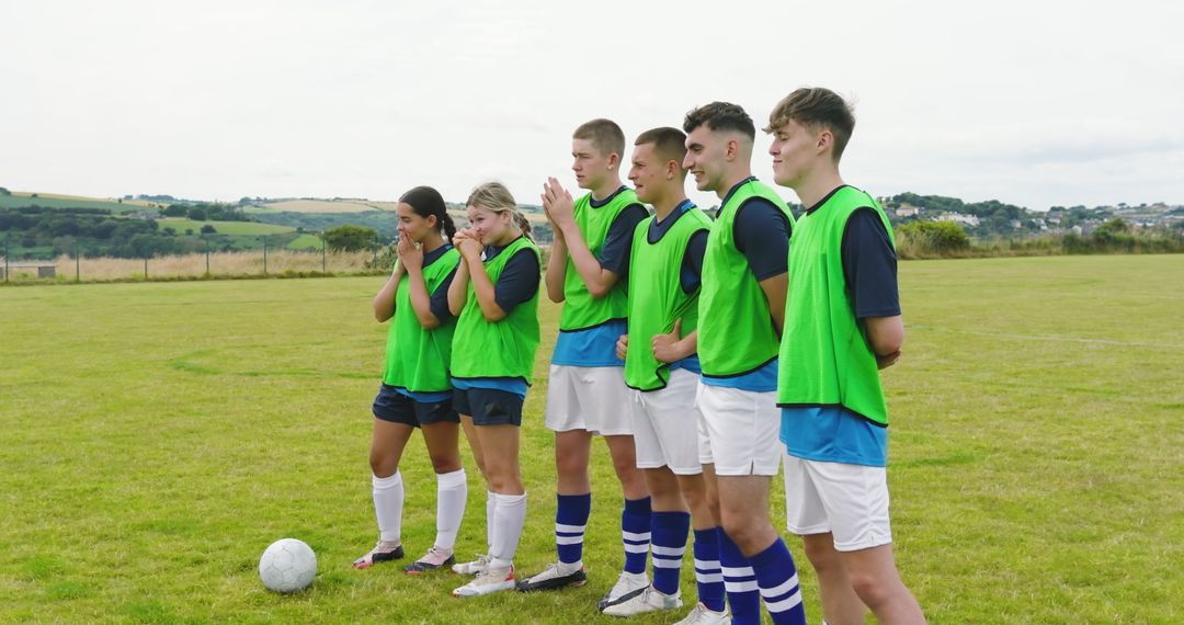 Soccer Team in Uniforms Ready for Training in Open Field