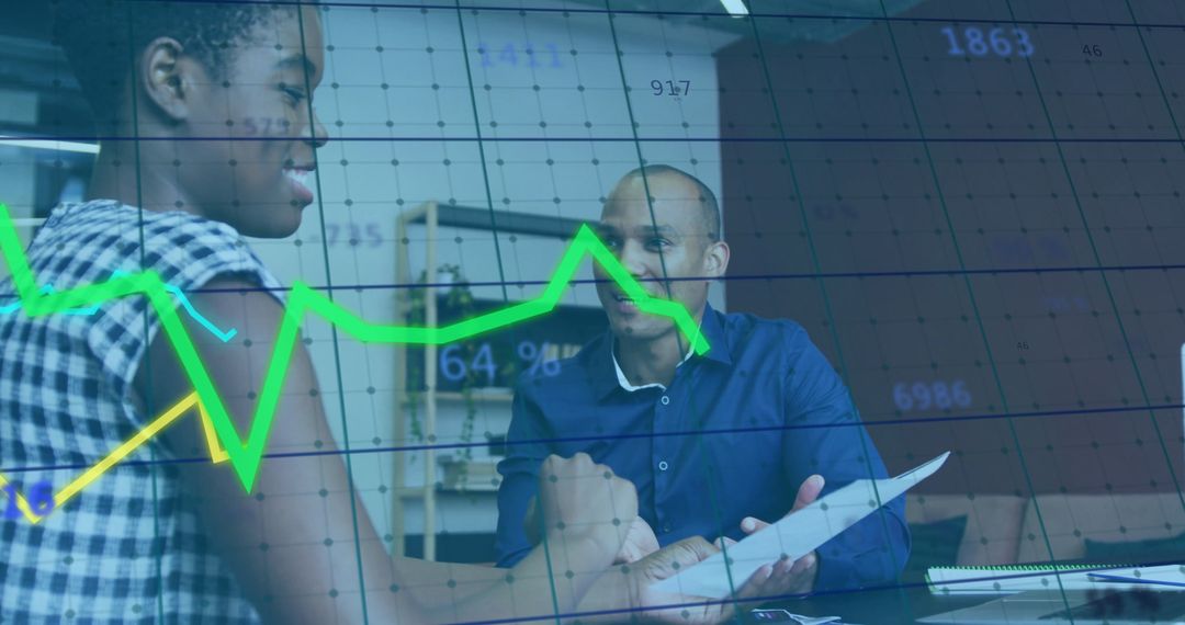 Colleagues Reviewing Data in Office with Overlay of Charts and Graphs