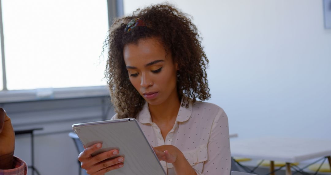 Young professional holding tablet in modern office