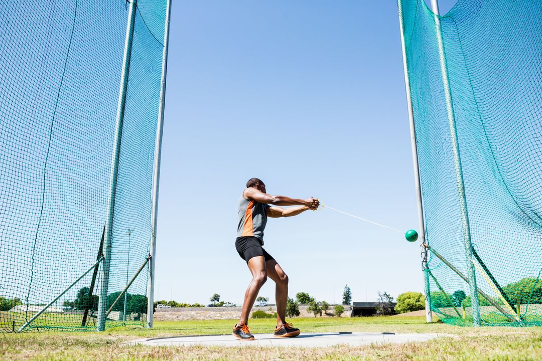 Athlete Executing Powerful Hammer Throw on Sunny Day