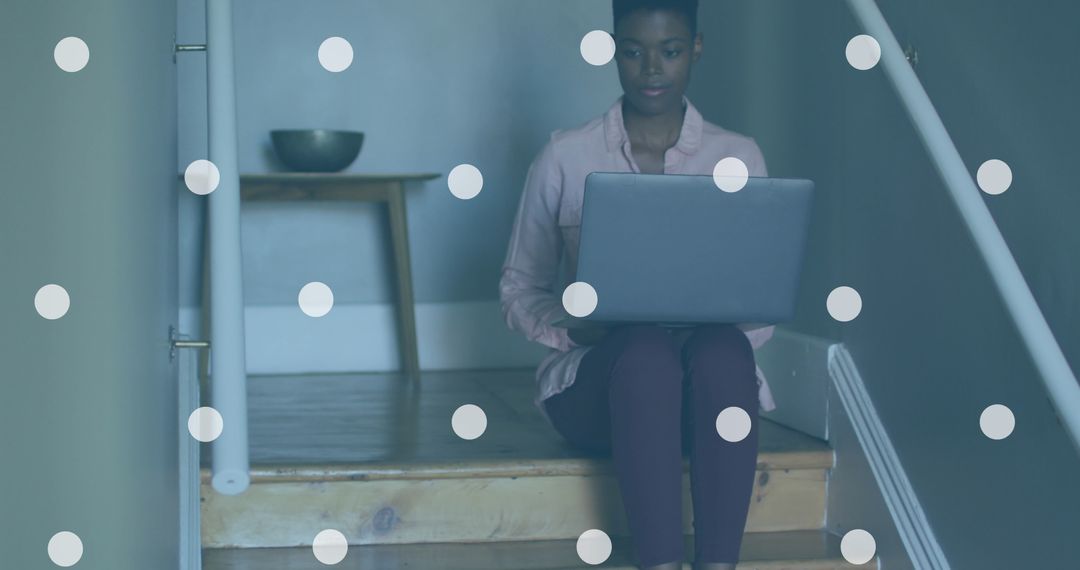 Woman Using Laptop on Stairs with Digital Overlay Effect