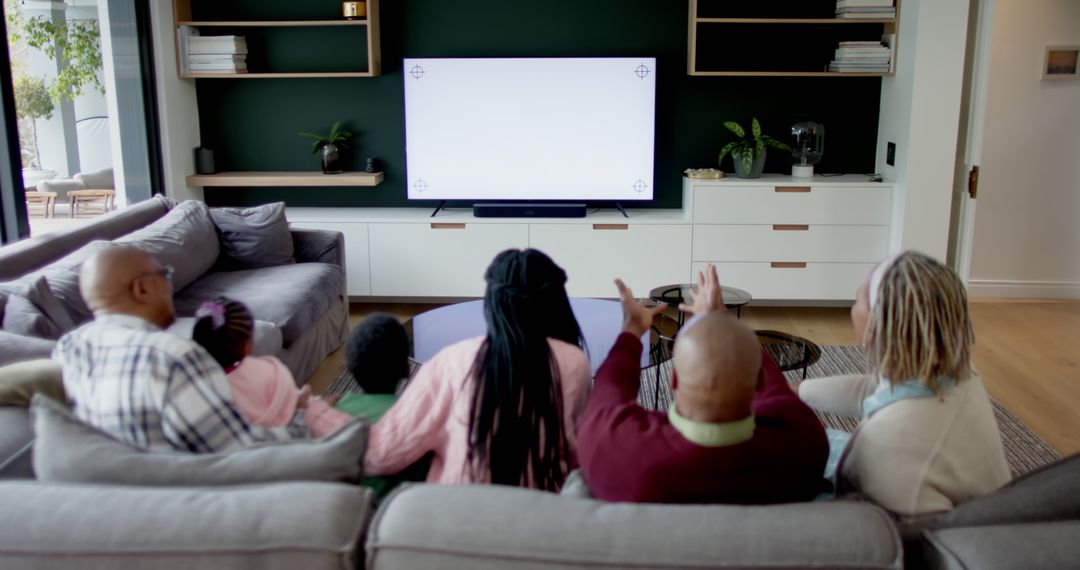 Family Watching Television Together in Modern Living Room - Free Images, Stock Photos and Pictures on Pikwizard.com