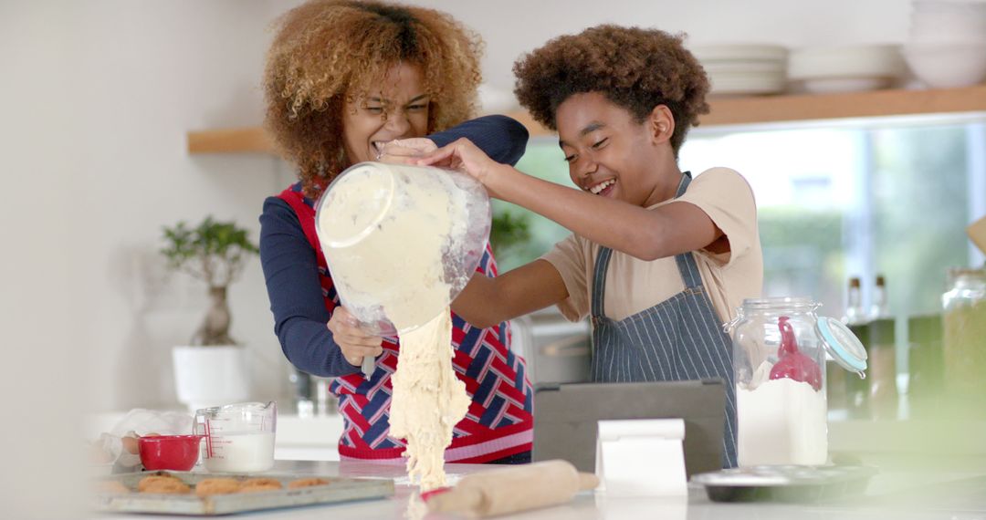 Mother and Son Baking with Joyful Expressions in Home Kitchen