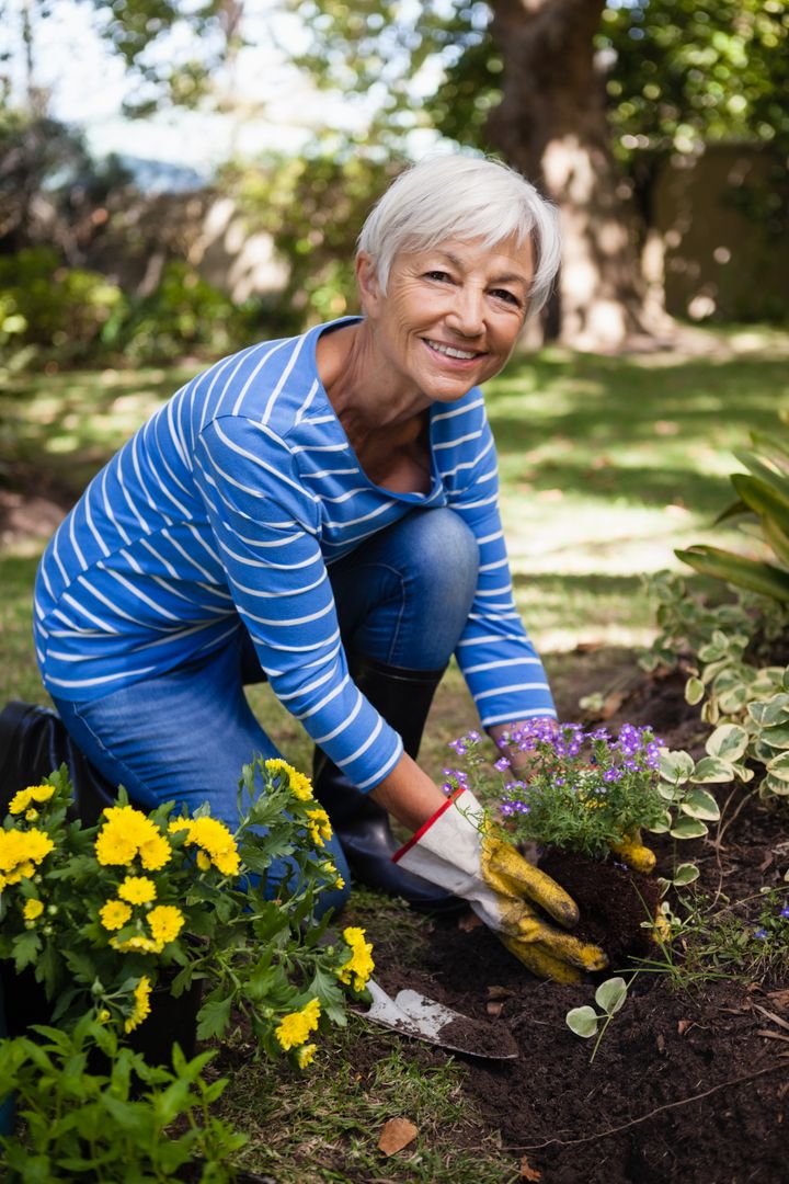 Senior Woman Planting Flowers in Garden - Free Images, Stock Photos and Pictures on Pikwizard.com