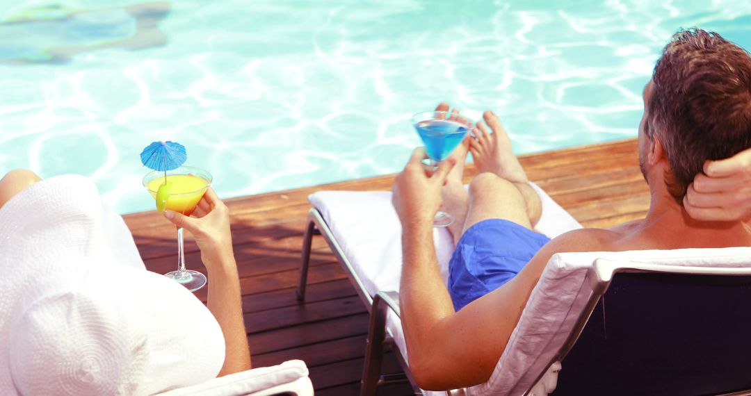 Couple Relaxing by Poolside with Colorful Cocktails - Free Images, Stock Photos and Pictures on Pikwizard.com