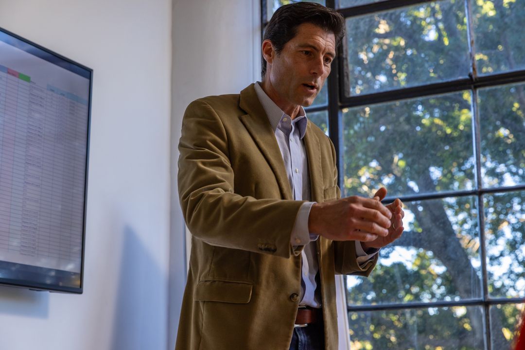 Business Professional Presenting Data in Modern Meeting Room