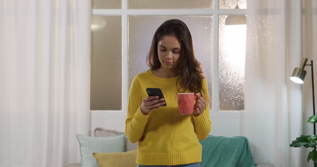 Woman enjoying morning coffee while using smartphone indoors - Free Images, Stock Photos and Pictures on Pikwizard.com