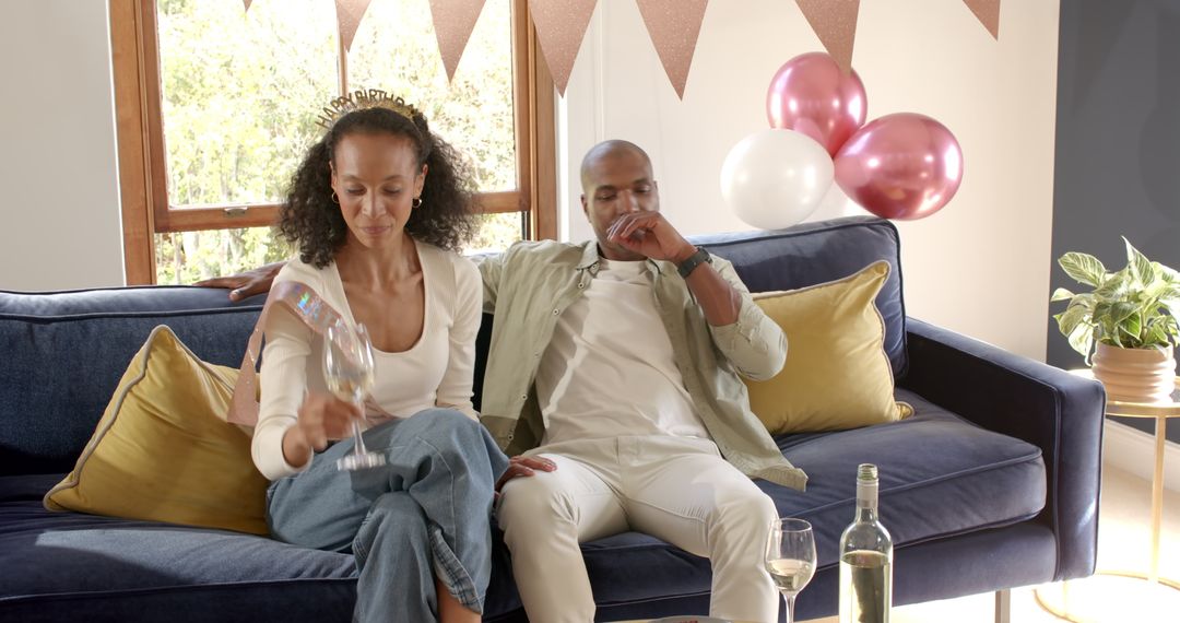Couple Relaxing with Wine During Home Celebration