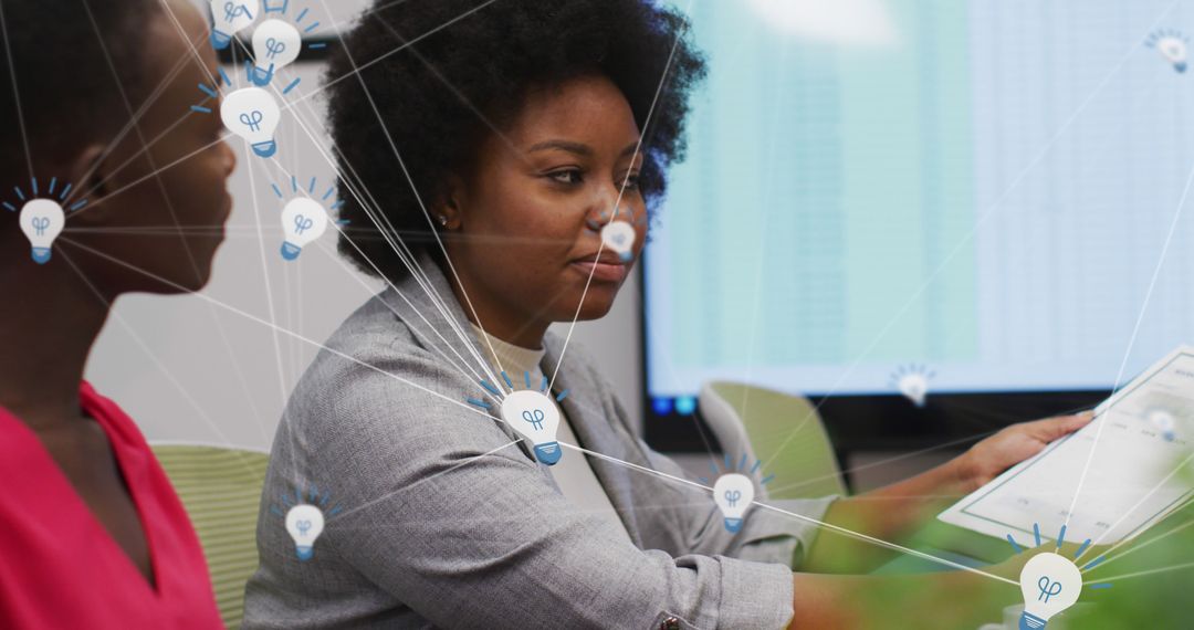 Diverse Business Team Analyzing Data on Tablet in Modern Office