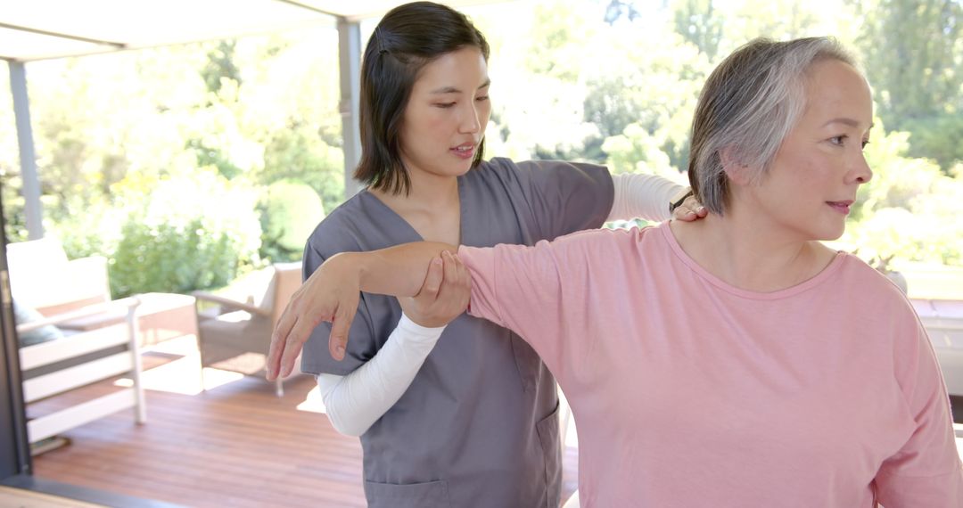 Physical Therapist Assisting Senior with Home Therapy Exercises