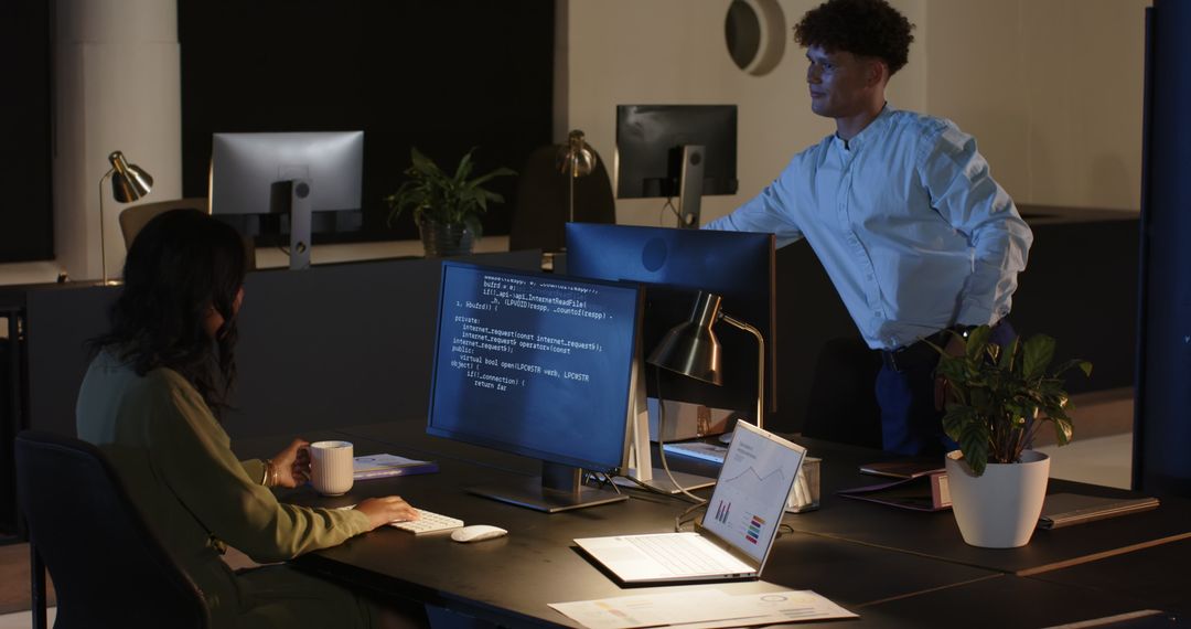 Diverse Team Collaborating at Nighttime Office with Technological Setup