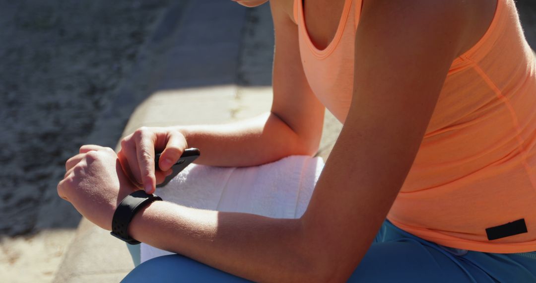 Woman Checking Smartwatch During Outdoor Workout - Free Images, Stock Photos and Pictures on Pikwizard.com