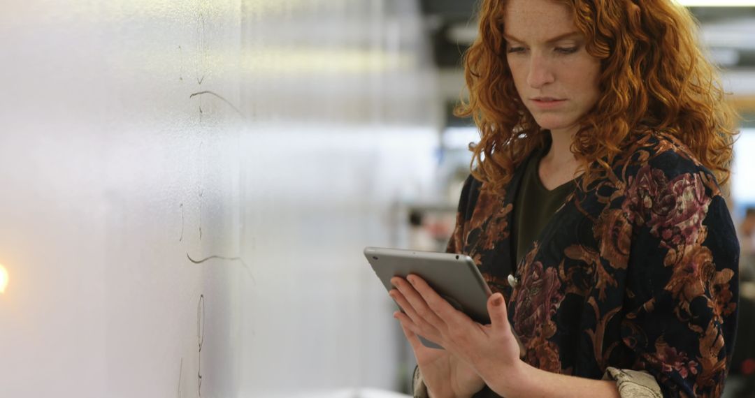 Red Haired Woman Using Tablet in Office Environment