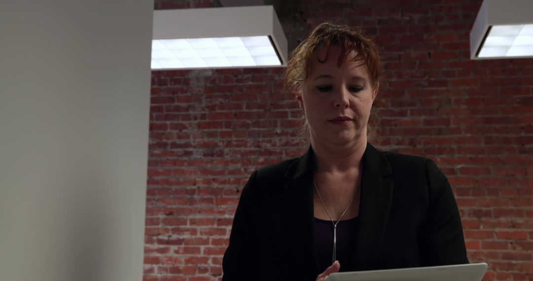 Businesswoman Using Tablet in a Modern Office Environment