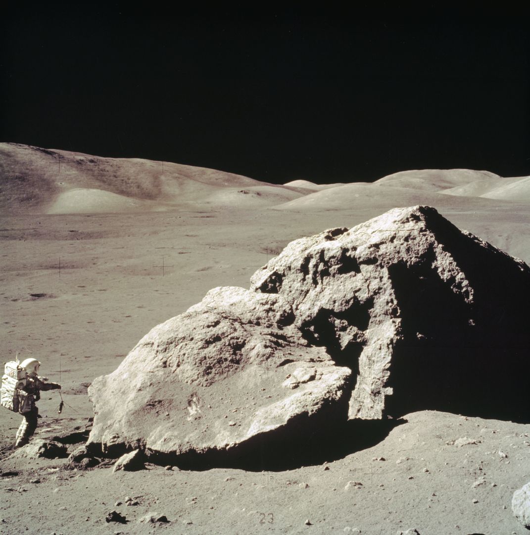 Astronaut Collecting Rock Samples Near Boulder on Moon During Apollo 17 Mission - Free Images, Stock Photos and Pictures on Pikwizard.com