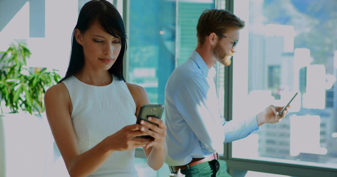 Business Professionals Nearby at Office, Engaging with Technology