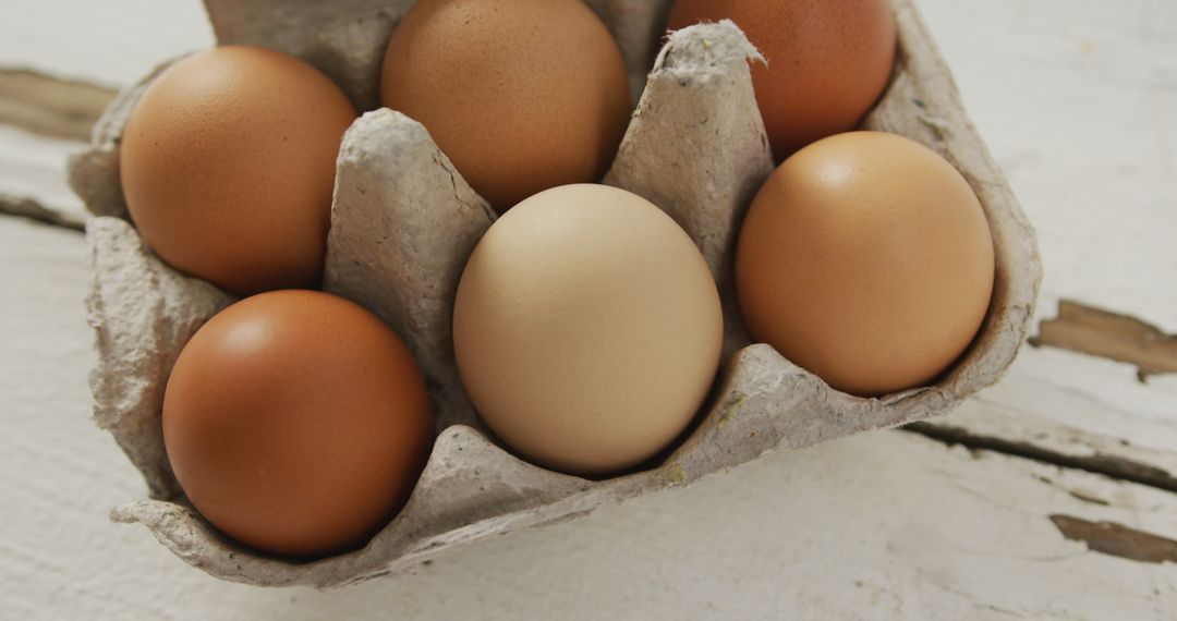 Assorted Brown Eggs in Recycled Carton on Rustic Table - Free Images, Stock Photos and Pictures on Pikwizard.com