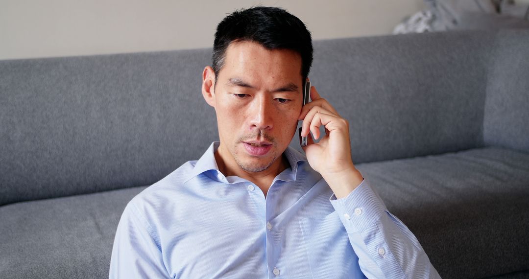 Businessman Talking on Phone While Sitting on Couch - Free Images, Stock Photos and Pictures on Pikwizard.com