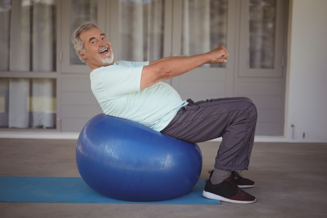 Senior Man Smiling While Exercising on Stability Ball Outdoors - Free Images, Stock Photos and Pictures on Pikwizard.com