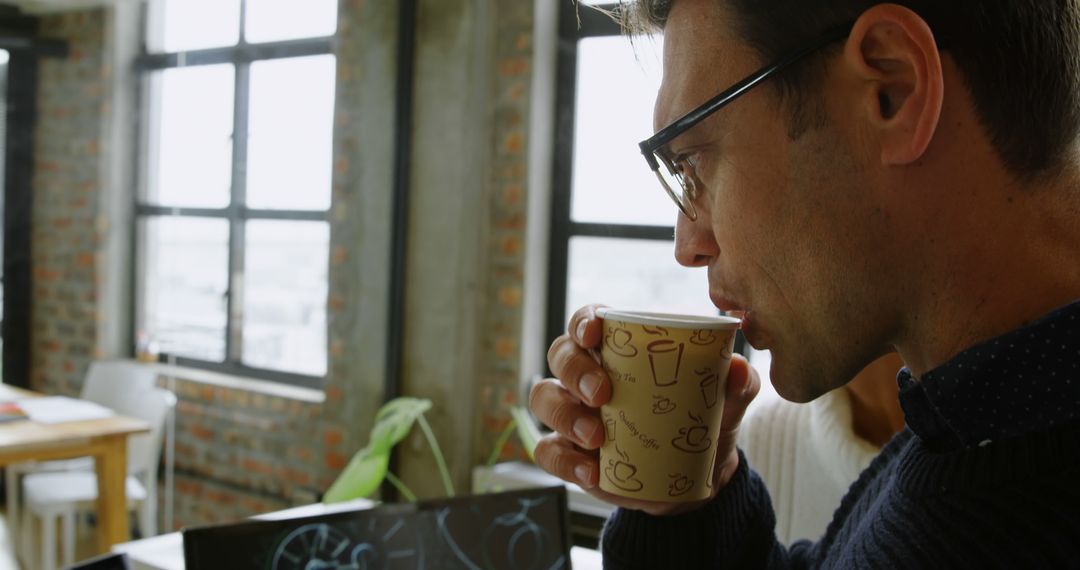 Man Drinking Coffee in Modern Industrial Office - Free Images, Stock Photos and Pictures on Pikwizard.com