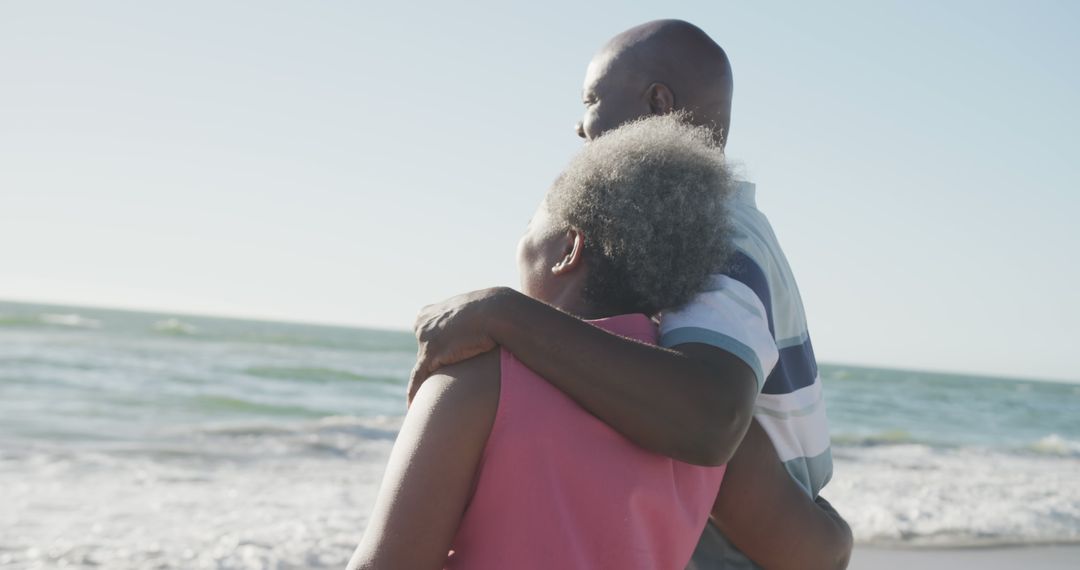 Elderly couple embracing on beach enjoying sunset - Free Images, Stock Photos and Pictures on Pikwizard.com