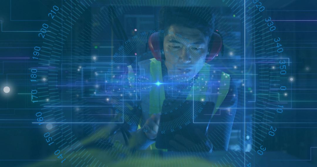 Engineer Using Tablet with Data Overlay in Modern Factory Setting