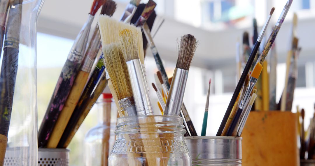 Collection of Artist Paintbrushes in Jars at Sunlit Studio - Free Images, Stock Photos and Pictures on Pikwizard.com