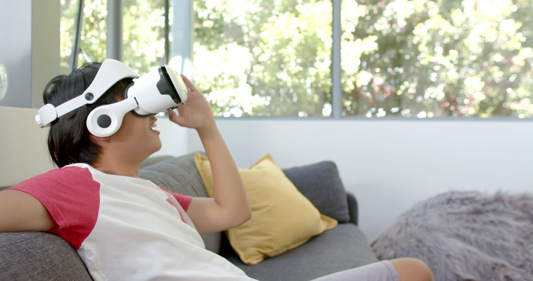 Young Man Experiencing Virtual Reality on Couch