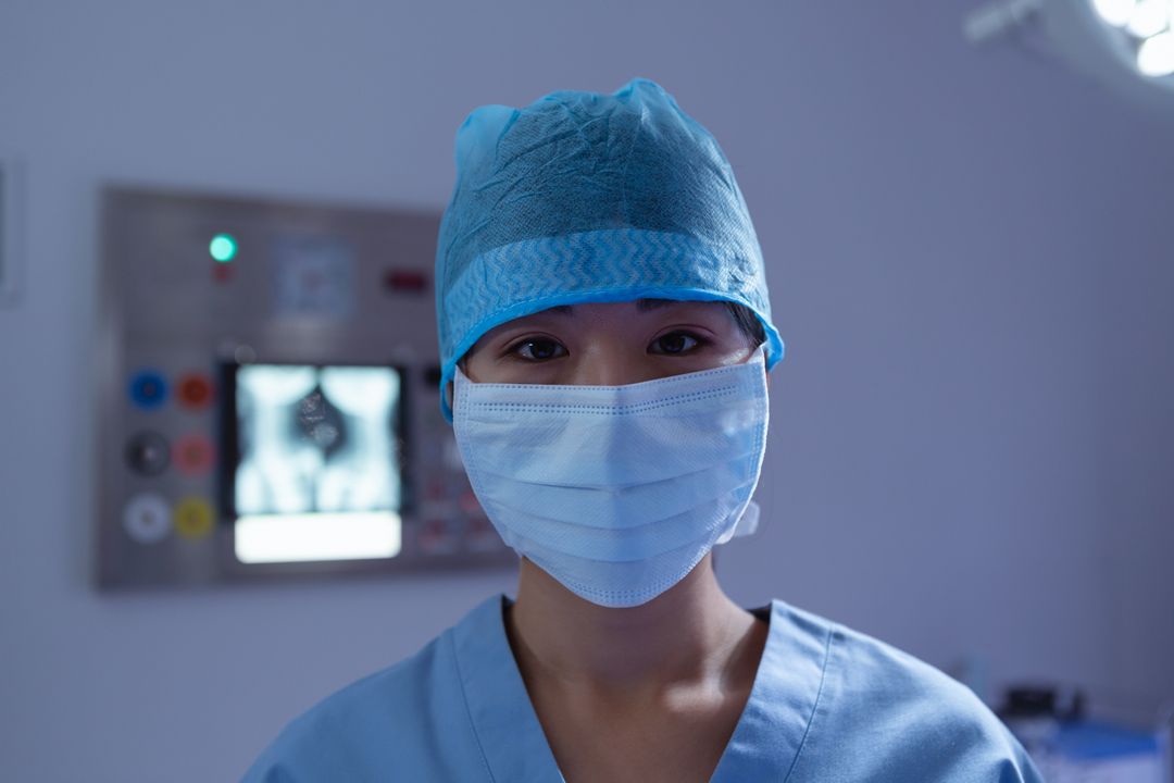 Female Surgeon Wearing Surgical Mask in Operating Room - Free Images, Stock Photos and Pictures on Pikwizard.com
