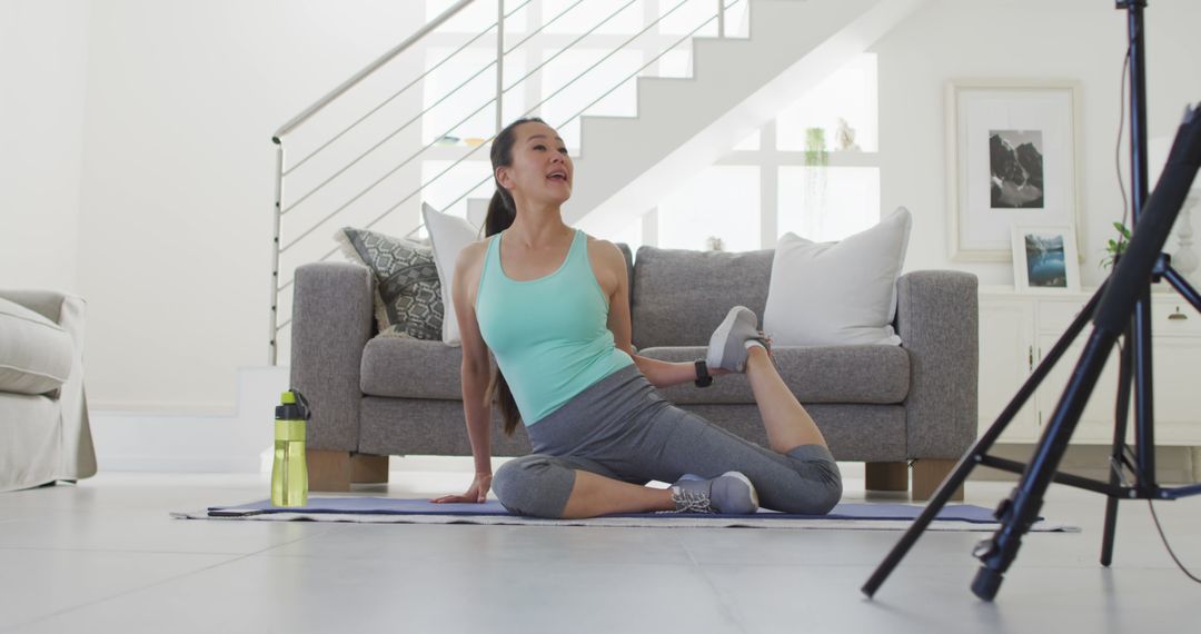 Woman Stretching in Living Room While Following Online Workout - Free Images, Stock Photos and Pictures on Pikwizard.com