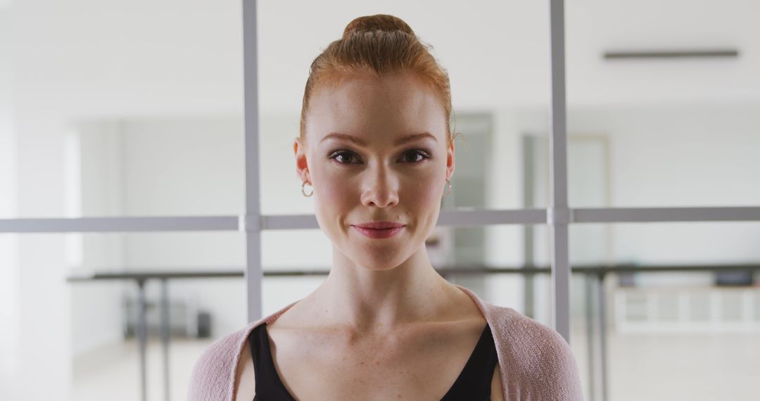Joyful Ballet Dancer Smiling in Bright Dance Studio Setting