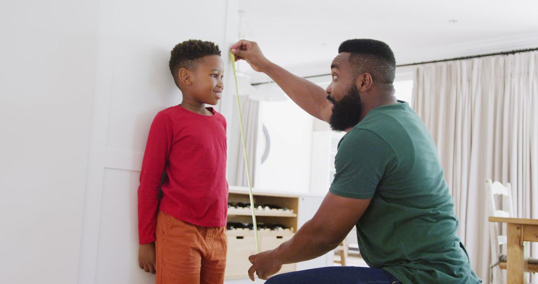 Father Measuring Height of Smiling Son at Home - Free Images, Stock Photos and Pictures on Pikwizard.com