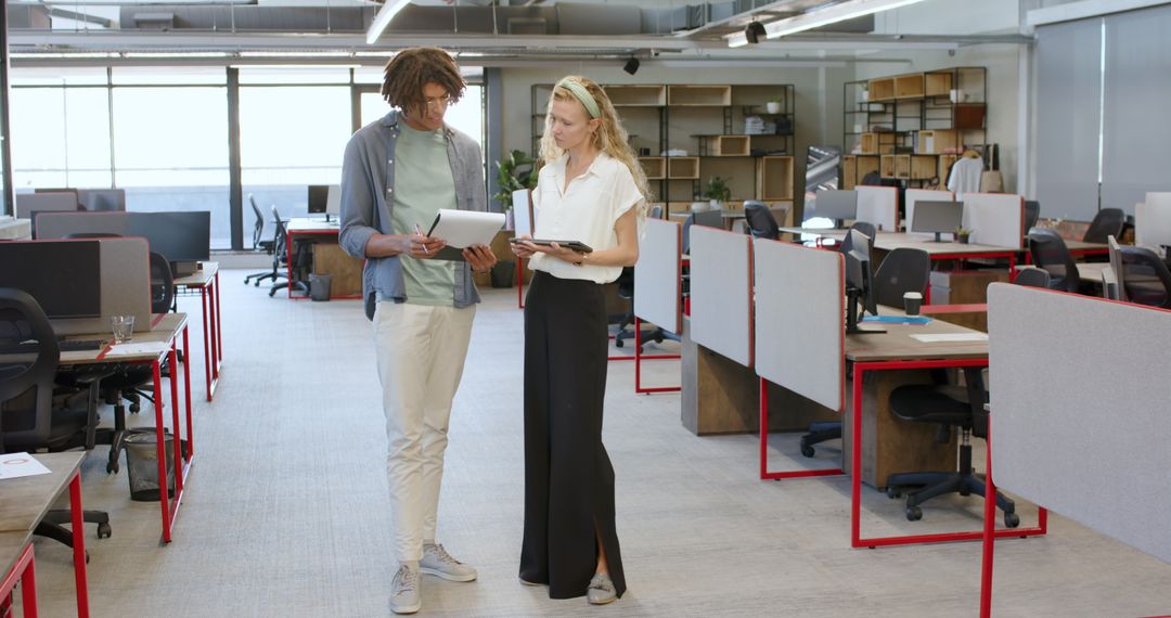 Colleagues Discussing Project in Modern Open-Plan Office