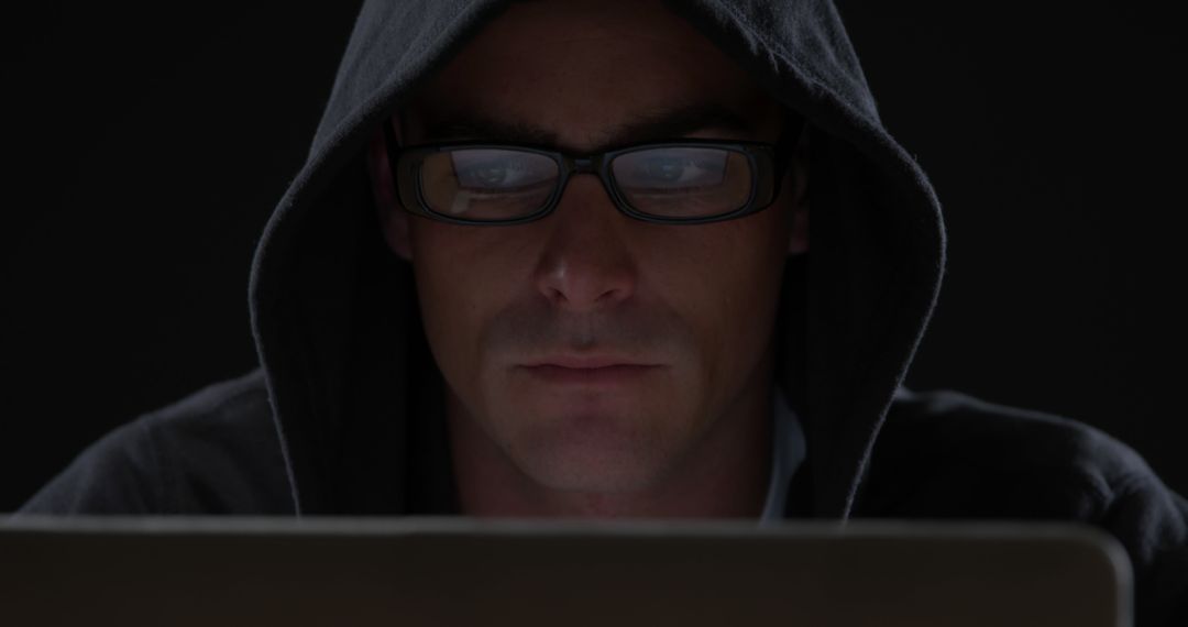 Mysterious Person in Hoodie Using Laptop in Dark Room - Free Images, Stock Photos and Pictures on Pikwizard.com