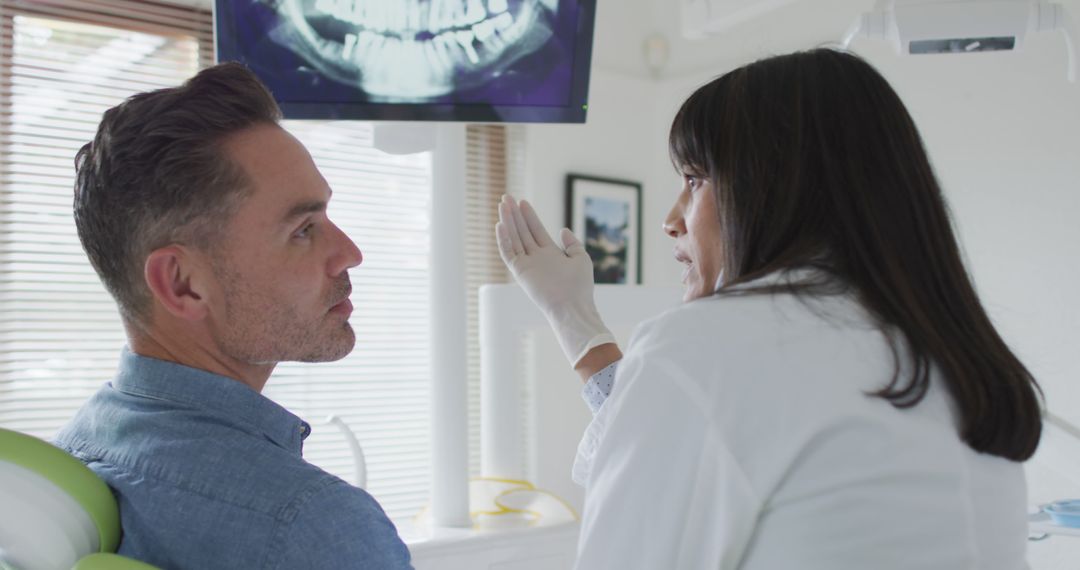 Dentist Discussing X-ray with Male Patient in Dental Clinic - Free Images, Stock Photos and Pictures on Pikwizard.com