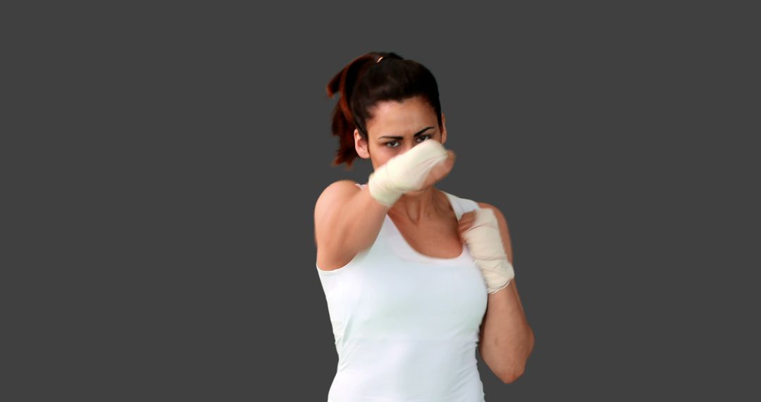 Fit Woman Practicing Boxing With Bandaged Fists - Free Images, Stock Photos and Pictures on Pikwizard.com