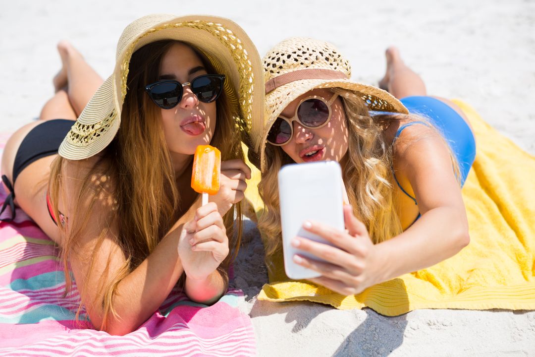 Female friends talking selfie while having popsicles - Free Images, Stock Photos and Pictures on Pikwizard.com