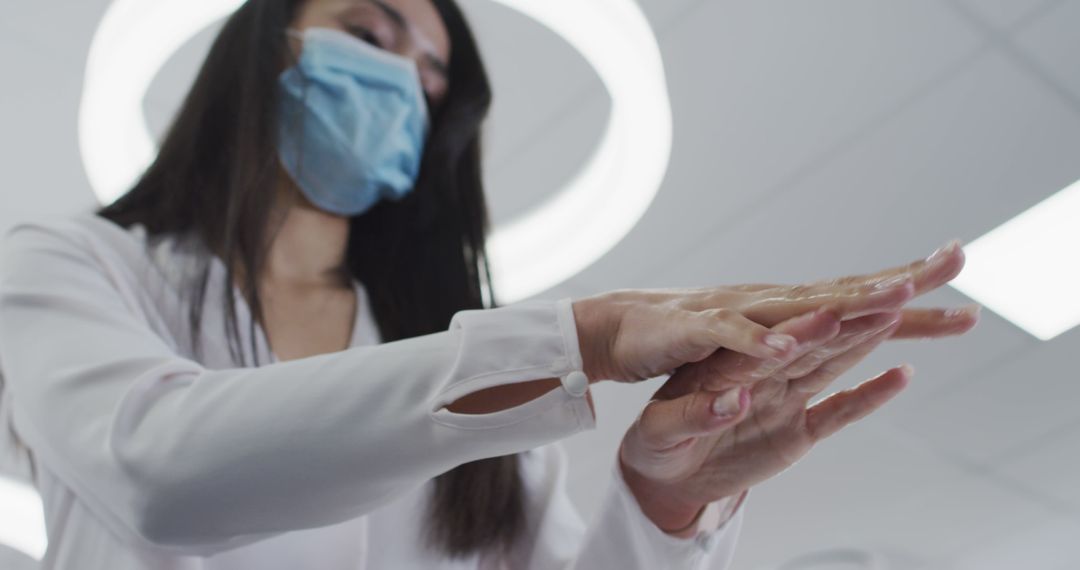 Healthcare Worker Applying Hand Sanitizer for Hygiene - Free Images, Stock Photos and Pictures on Pikwizard.com