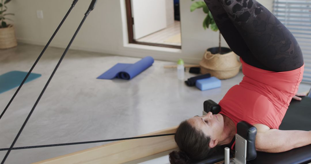 Woman Practicing Pilates Reformer Exercises Indoors - Free Images, Stock Photos and Pictures on Pikwizard.com