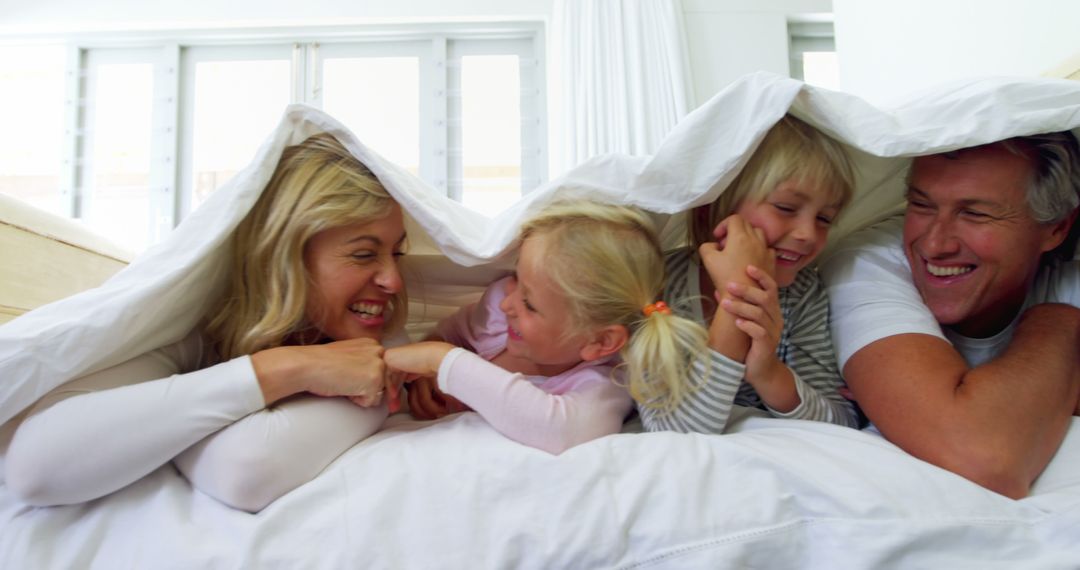 Happy Family Playing Under Blanket in Bedroom - Free Images, Stock Photos and Pictures on Pikwizard.com