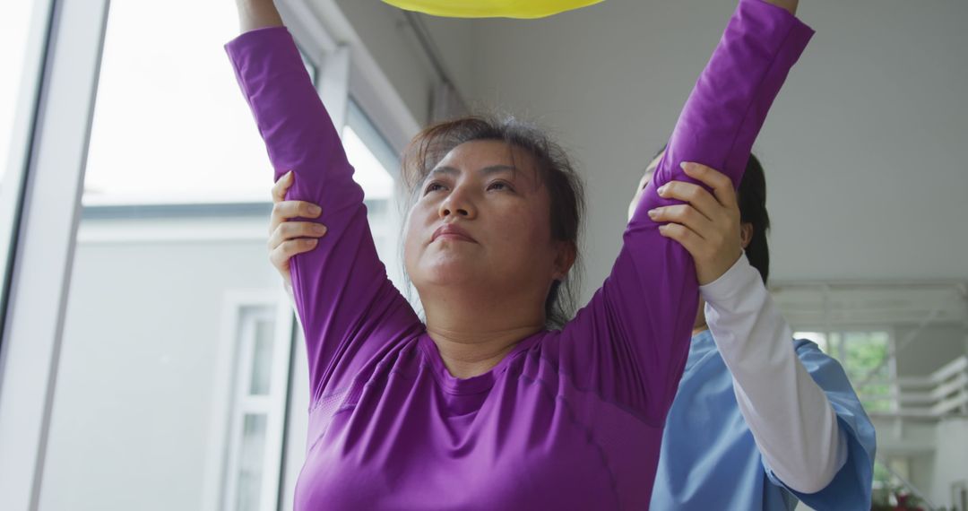 Physical Therapist Assisting Female Patient with Arm Exercises - Free Images, Stock Photos and Pictures on Pikwizard.com