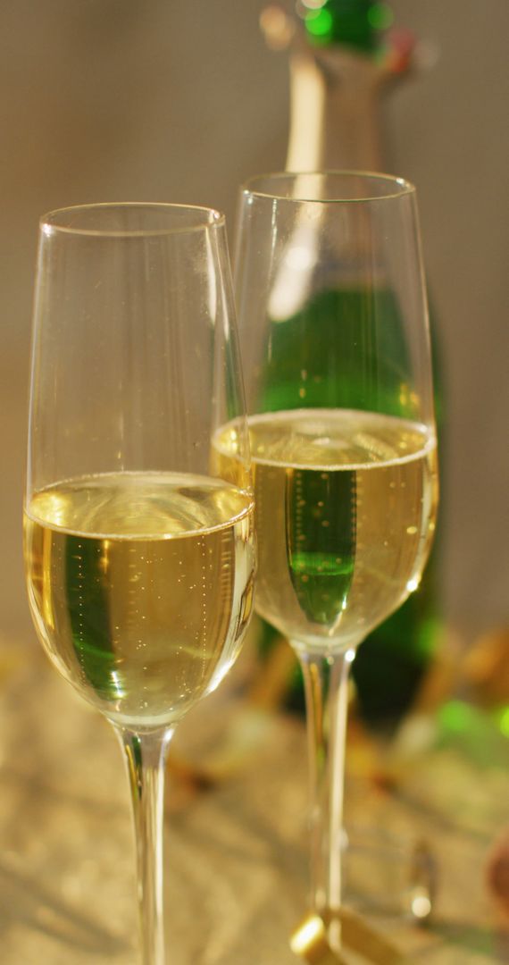 Two Elegant Glasses of Champagne with Bottle in Background