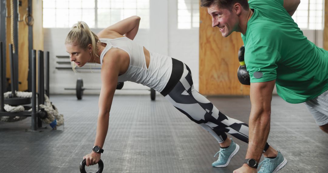 Caucasian Couple Exercising with Kettlebells in Gym Focus and Determination