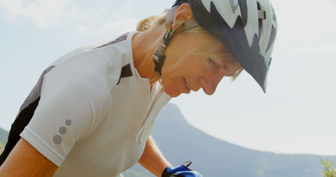 Senior Woman Preparing for Mountain Bike Ride Outdoors - Free Images, Stock Photos and Pictures on Pikwizard.com